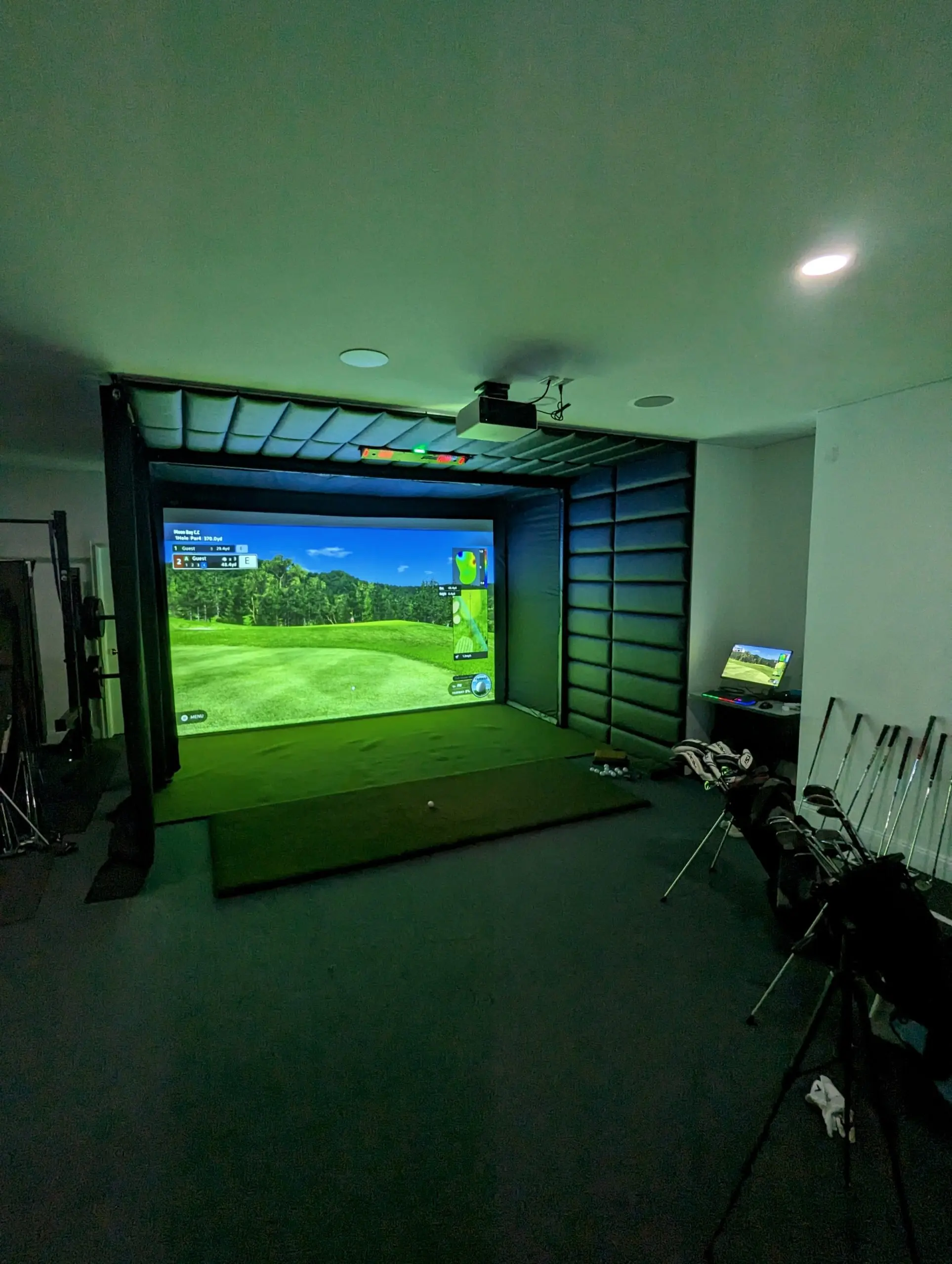 Full-room view of an indoor golf simulator installation