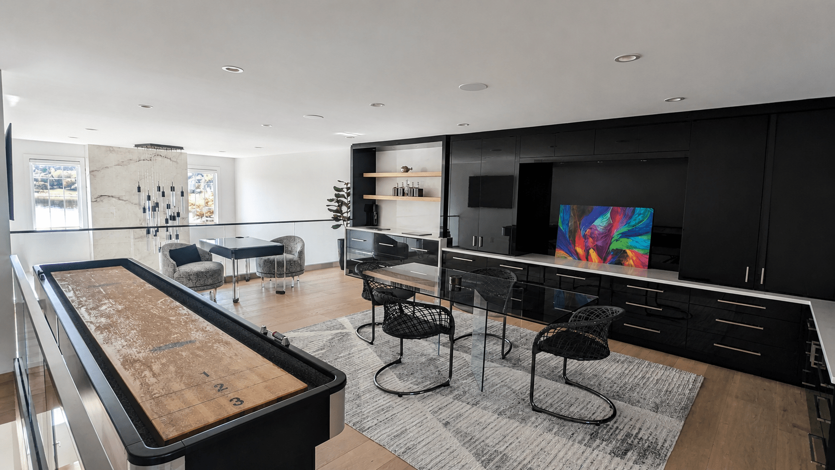 Upper-level entertainment lounge with an integrated display and ceiling speakers