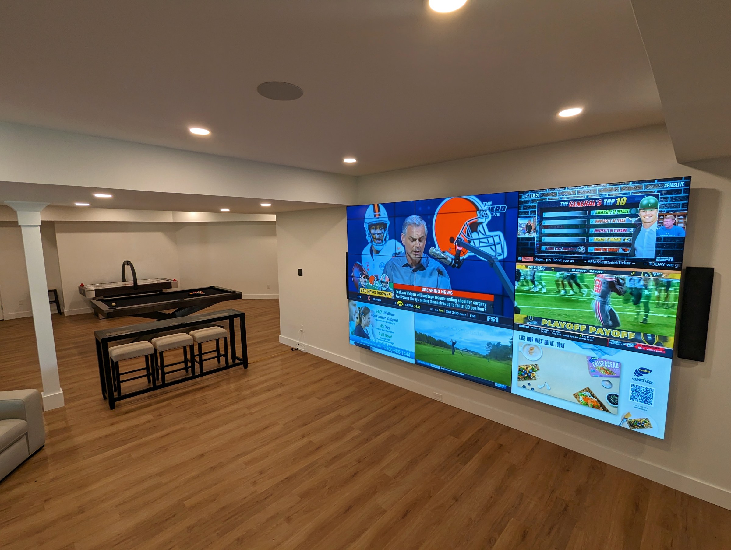 Entertainment room with multiple integrated displays and an adjacent game area