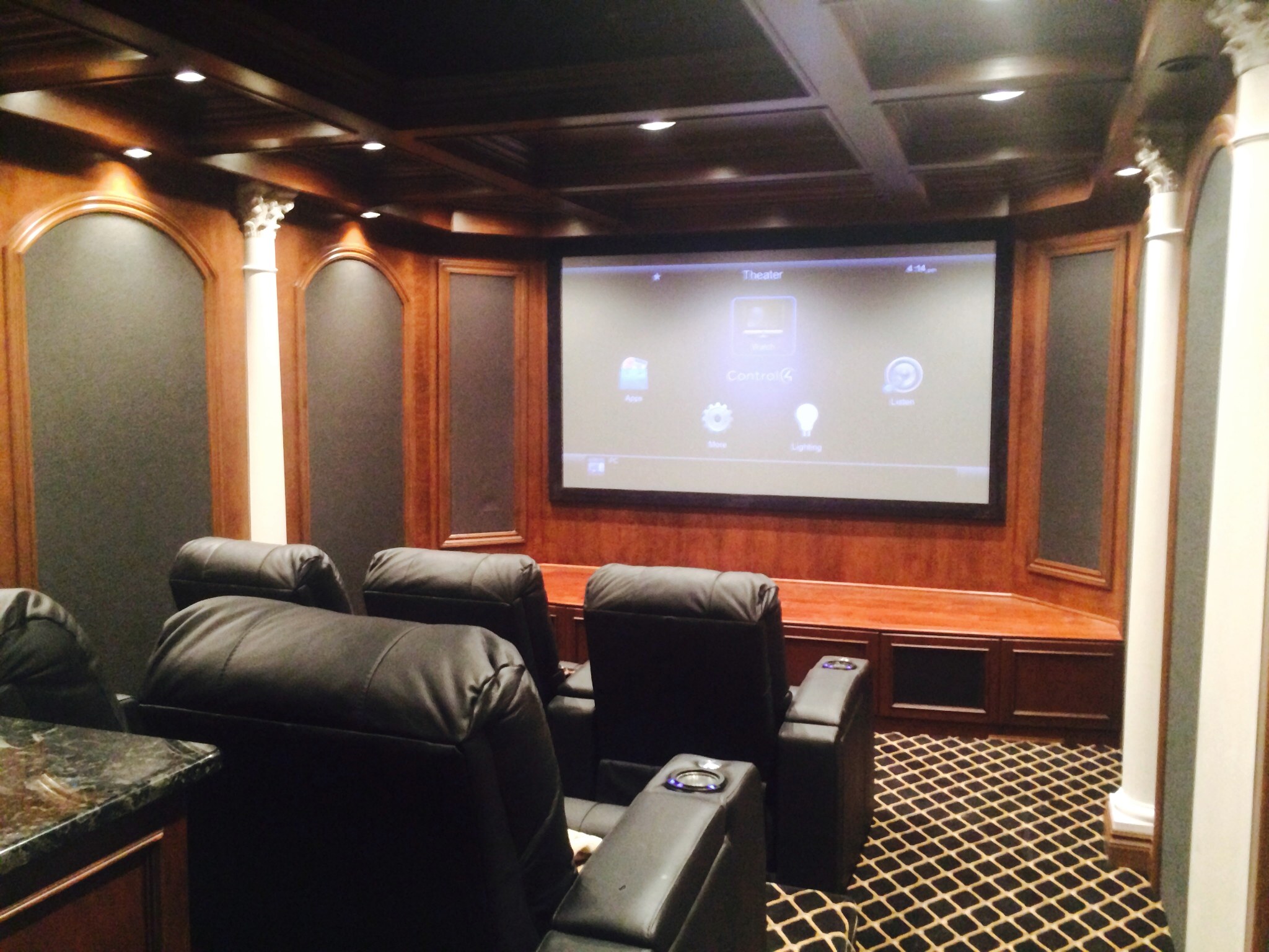 Traditional dedicated home theater with projection screen and cinema seating