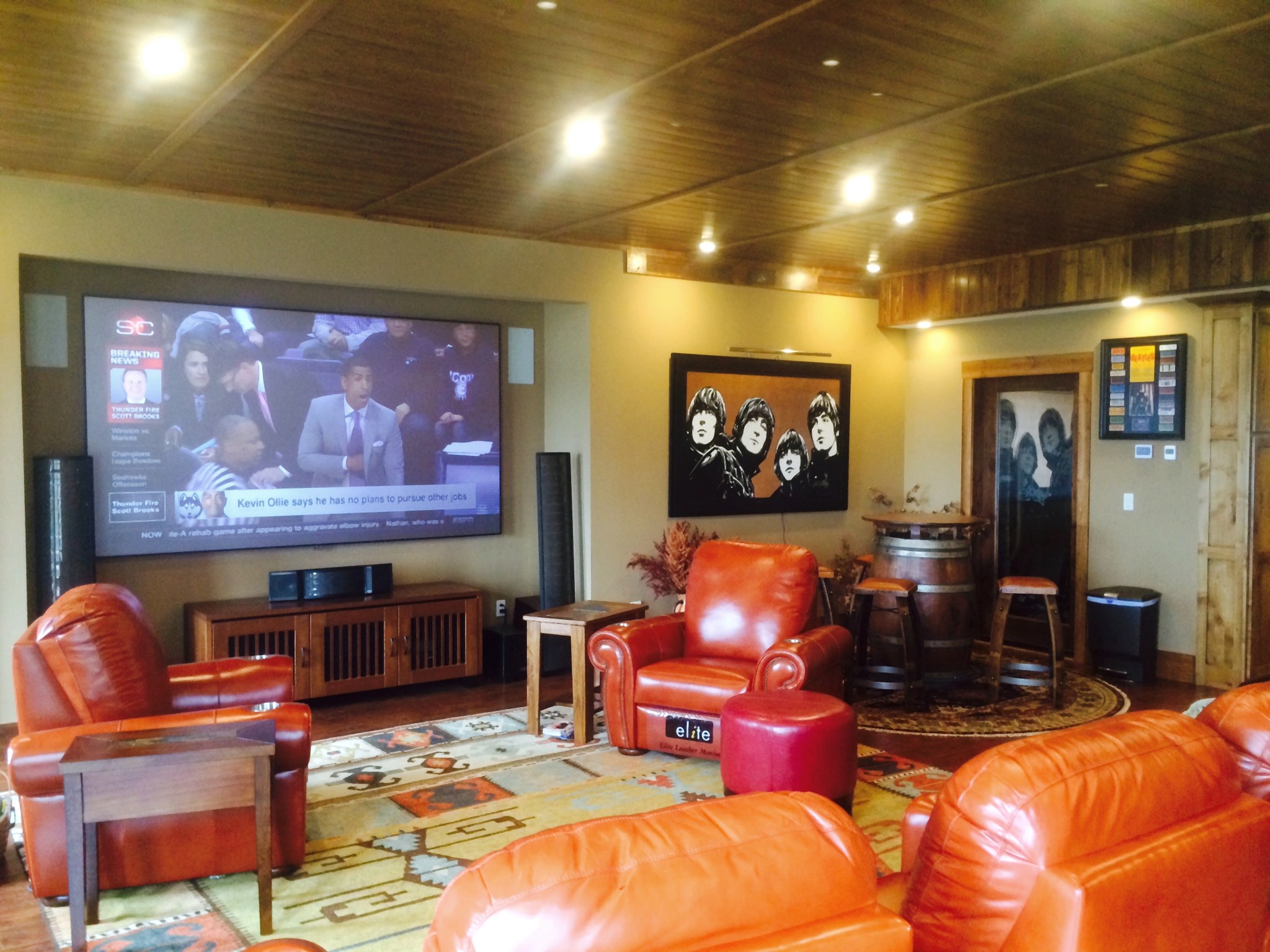Comfortable media room with a large display and integrated audio